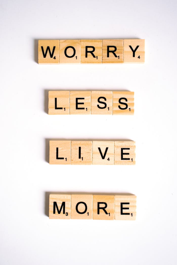 Motivational quote made from Scrabble tiles on a white background, inspiring positivity.